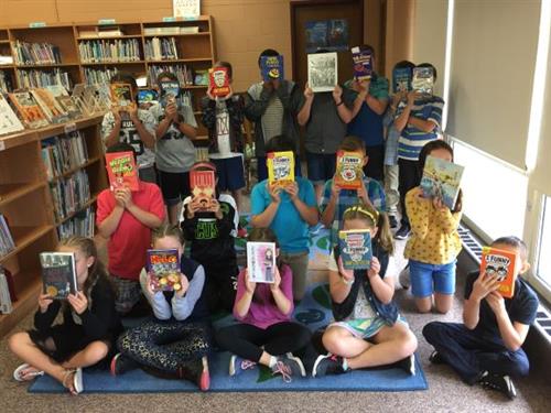 4th grade students looking at new books 4th grade students looking at new books